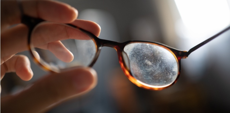 A pair of glasses with scratched and dirty lenses