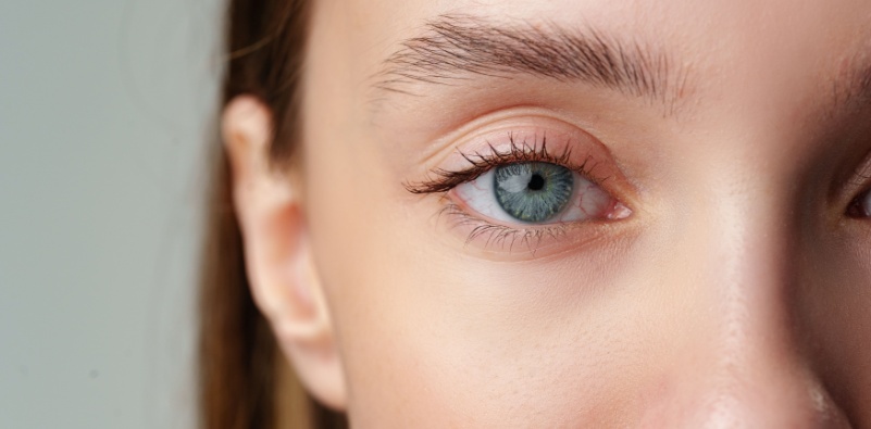 A close-up of a young woman’s blue eye