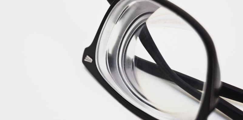 Isolated close up of a pair of eyeglasses with thick lenses.