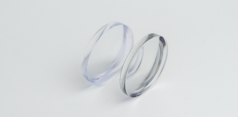 A pair of uncut prescription eyeglasses lenses side by side to show lens thickness.