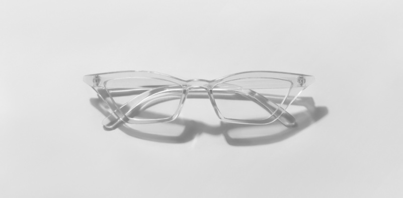 Eyeglasses on a white background in the new trending PANTONE Cloud Dancer color of 2026 year.