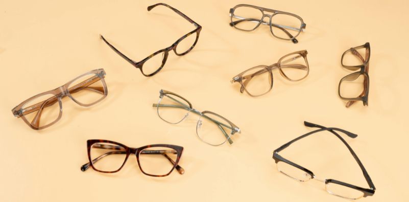 A collection of different shape and color eyeglasses on a yellow background